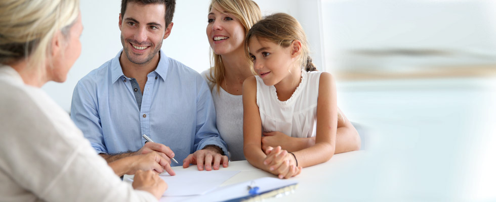 A family looking over a piece of paper